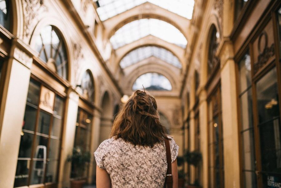 Paris: Covered Passages Walking Tour - Passage Choiseul under the glass roof: sunlit shops and tiled-floor angles
