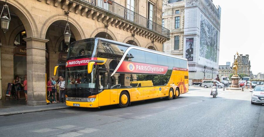 Paris: Openair Double Decker Bus Audio-Guided City Tour - Sliding into a panoramic, enclosed double-decker (and what to do with it)