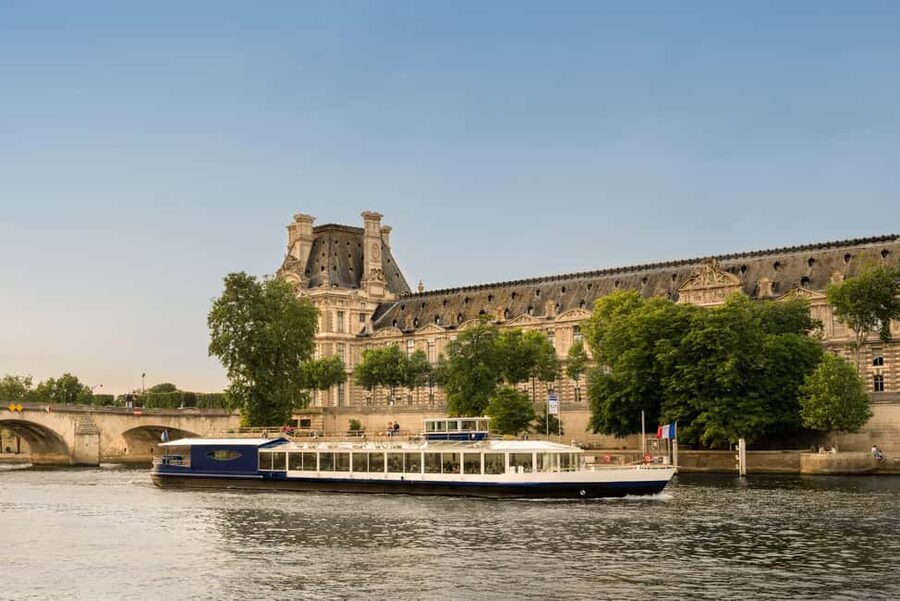 Paris: Seine River Panoramic Views Dinner Cruise - The boat setup: club armchairs, panoramic windows, and a terrace