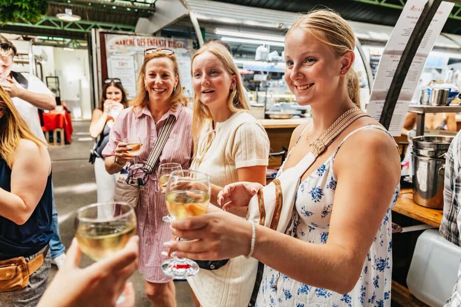 Paris: Walking Food Tour with Cheese, Wine and Delicacies - Cheese and wine tastings, with baguette-first logic