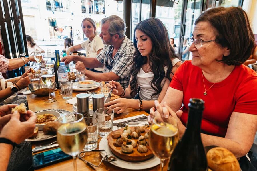 Paris: Walking Food Tour with Cheese, Wine and Delicacies - The one restaurant stop, where you sit down and refill